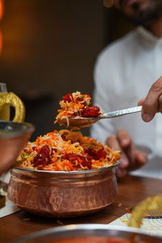 a man is spooning food out of a bowl