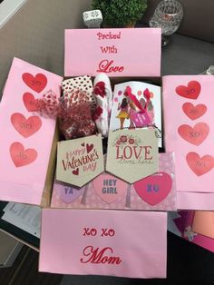 valentine's day boxes are arranged on a table with cards and other items in them