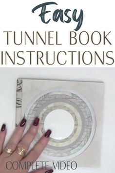 a woman's hand with red nail polish and gold rings on her fingers, next to an easy book instructions