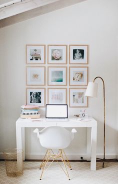 a white desk with pictures on the wall