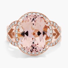 an oval shaped pink stone surrounded by white diamonds in a rose gold ring with diamond accents