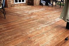 a wooden deck with chairs and an umbrella