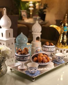 a tray with some food on top of it next to vases and other items