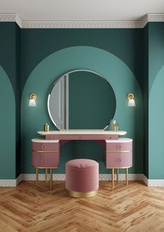 a pink vanity and stool in front of a green wall with a round mirror on it