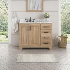 a bathroom vanity with two mirrors above it and a rug on the floor next to it