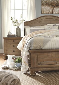 a bed sitting in a bedroom next to a dresser with drawers on top of it