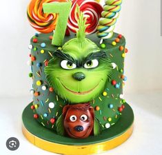 the grin face cake is decorated with candies and lollipops