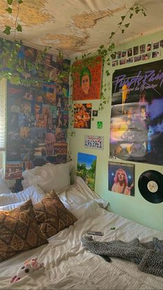 a bedroom with posters on the wall and bed