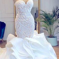 a white wedding dress on display in front of a mirror