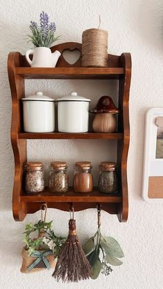 a shelf filled with jars and spices on top of a wall