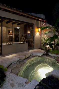 an outdoor hot tub lit up at night