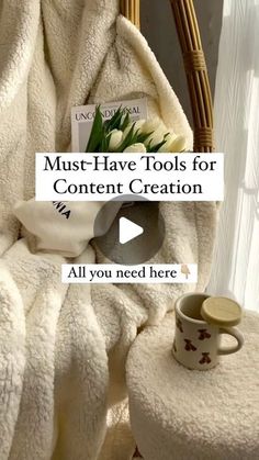 a basket with flowers and a cup on it next to a white blanket that says must have tools for content creation all you need here