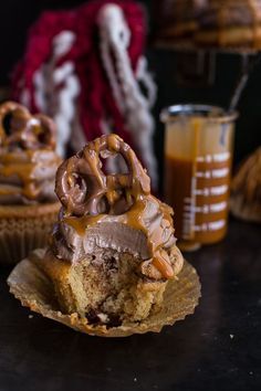 a cupcake with chocolate frosting and pretzels on top