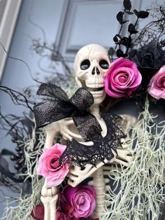 a skeleton with flowers in it's hand and a black bow on its head