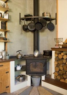 an old fashioned stove with pots and pans on it's burners in a kitchen