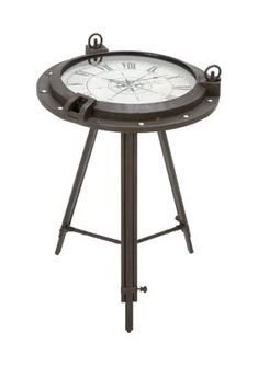 a clock on a metal stand with two hands and an iron frame around the face