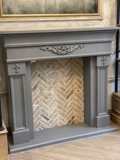 an ornate fireplace surround in grey painted wood