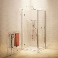 a bathroom with a stand up shower next to a towel rack