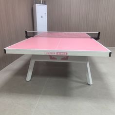 a pink ping pong table in a room