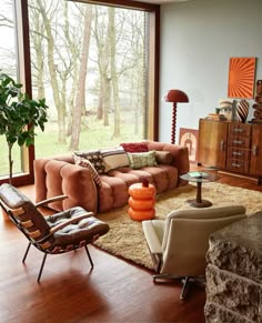 a living room filled with furniture and large windows