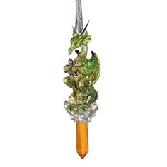 a green dragon figurine hanging from a crystal ball on a chain with an orange bead