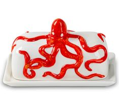 an octopus on a white plate with red paint