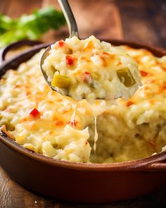 a spoon full of mashed potatoes on a wooden table