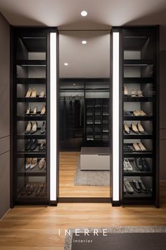 a walk in closet filled with lots of shoes and lighting on the wall behind it