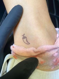 a woman's foot with a small tattoo on the side of her leg,