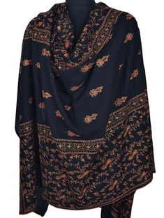 The deep jet-black color provides a striking backdrop for the elaborate Sozni needlework. Each motif is carefully stitched, with swirling teardrop shapes and delicate curls that make every one unique. The amount of detail in the embroidery speaks to the skill and artistry of the expert Kashmir artisan who made this shawl. Quality: Highest-Quality 100% Pure Pashmina Size: 40x80 inch or 100x200 cm Origin: Kashmir, INDIA.  Warm, Smooth, Super Soft, Symbol of Luxury This is our high grade Pashmina line. Retail Store Price: Over US$5000 Pashmina Kashmiri Embroidered Shawl or chain stitched shawls are a popular art of kashmir, crafted by skilled craftsman. Its a very rare contribution of art to the world by the people of Kashmir. These heirloom items are found in all corners of the earth, in ric Black Pashmina Shawl With Intricate Embroidery, Black Intricate Embroidery Pashmina Shawl, Black Embroidered Pashmina Shawl, Black Shawl With Intricate Embroidery In Traditional Drape, Black Pashmina Shawl With Motifs, Black Pashmina Shawl With Traditional Motifs, Black Pashmina Shawl With Motifs In Traditional Drape, Festive Black Pashmina Shawl With Traditional Patterns, Black Pashmina Shawl In Traditional Drape