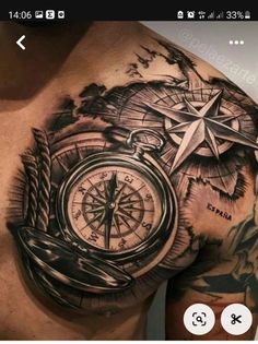 a man's chest with a compass tattoo on it