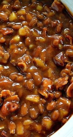 a bowl filled with beans and meat on top of a table