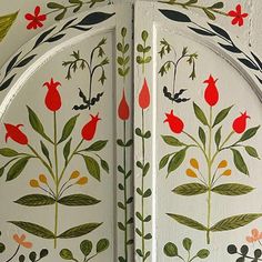 an intricately painted door with flowers and leaves