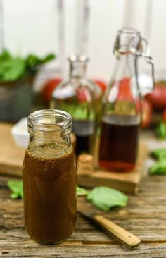 a jar filled with liquid sitting on top of a wooden table