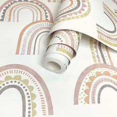 a wallpaper with rainbows on it and white paper in the middle that is rolled up