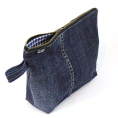 a small denim pouch with zippers on the inside is shown in front of a white background