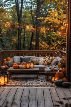 an outdoor seating area with candles and pumpkins