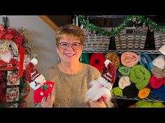 a woman standing in front of christmas decorations