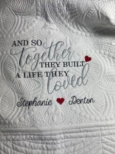 a white quilt with the words and two hearts on it that says, and so together they built a life they loved