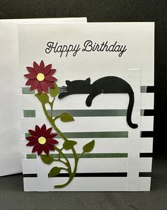 a card with a cat and flowers on it