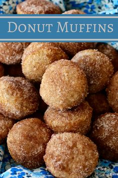 a pile of donut muffins sitting on top of a blue and white cloth