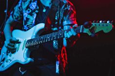 a man playing an electric guitar on stage