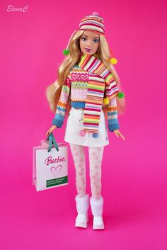 a barbie doll is holding a shopping bag