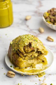 These gooey sticky pistachio buns are the perfect eggless and dairy-free treat! Fluffy cinnamon roll dough is slathered with pistachio cream, pistachio pieces, and cinnamon sugar before it is rolled up and baked in a thick pistachio cream sauce.