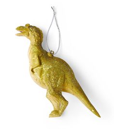 a gold dinosaur ornament hanging from a chain