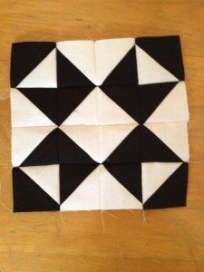 a piece of black and white fabric on top of a wooden table