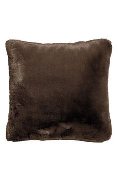 a dark brown pillow with fur on the front and back side, sitting on a white background