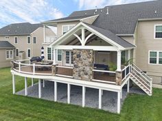 a house with a deck and stone wall