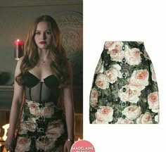 a skirt with roses on it and a candle in the background