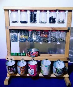 a wooden shelf with jars and cans on it